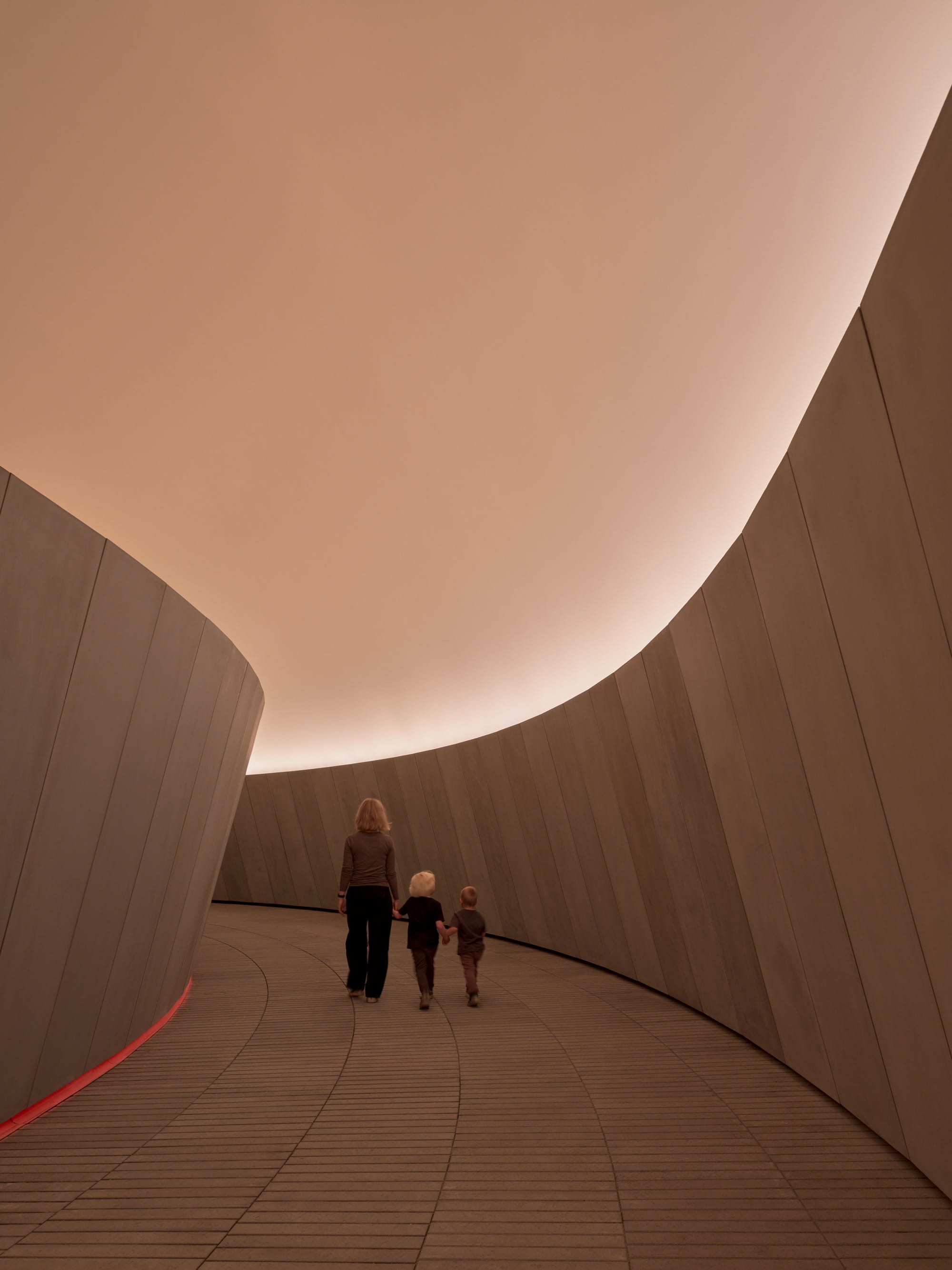 People walking down a corridor inside James Turrells As Seen Below