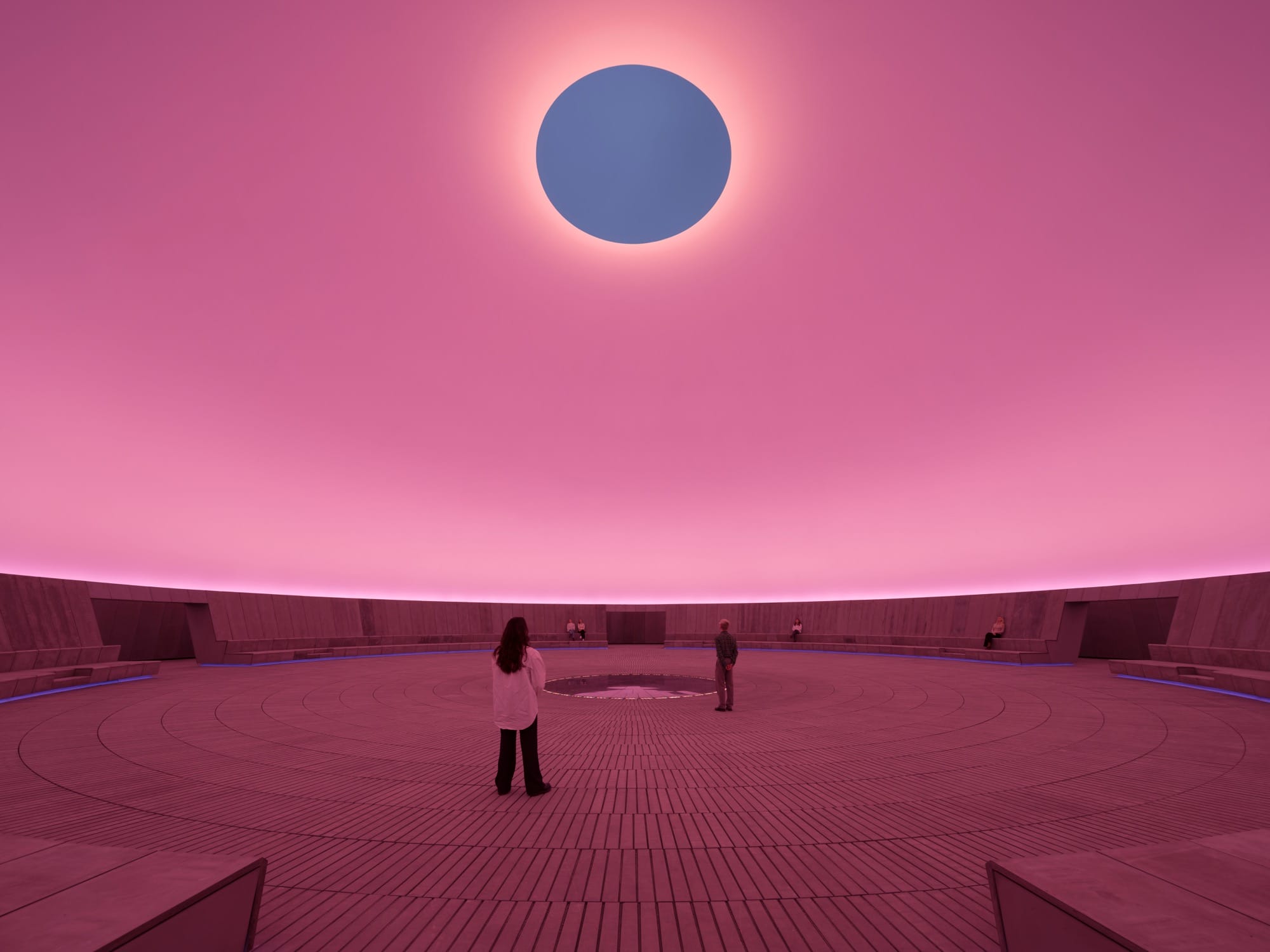 James Turrell light installation with a gray oculus in a pink dome