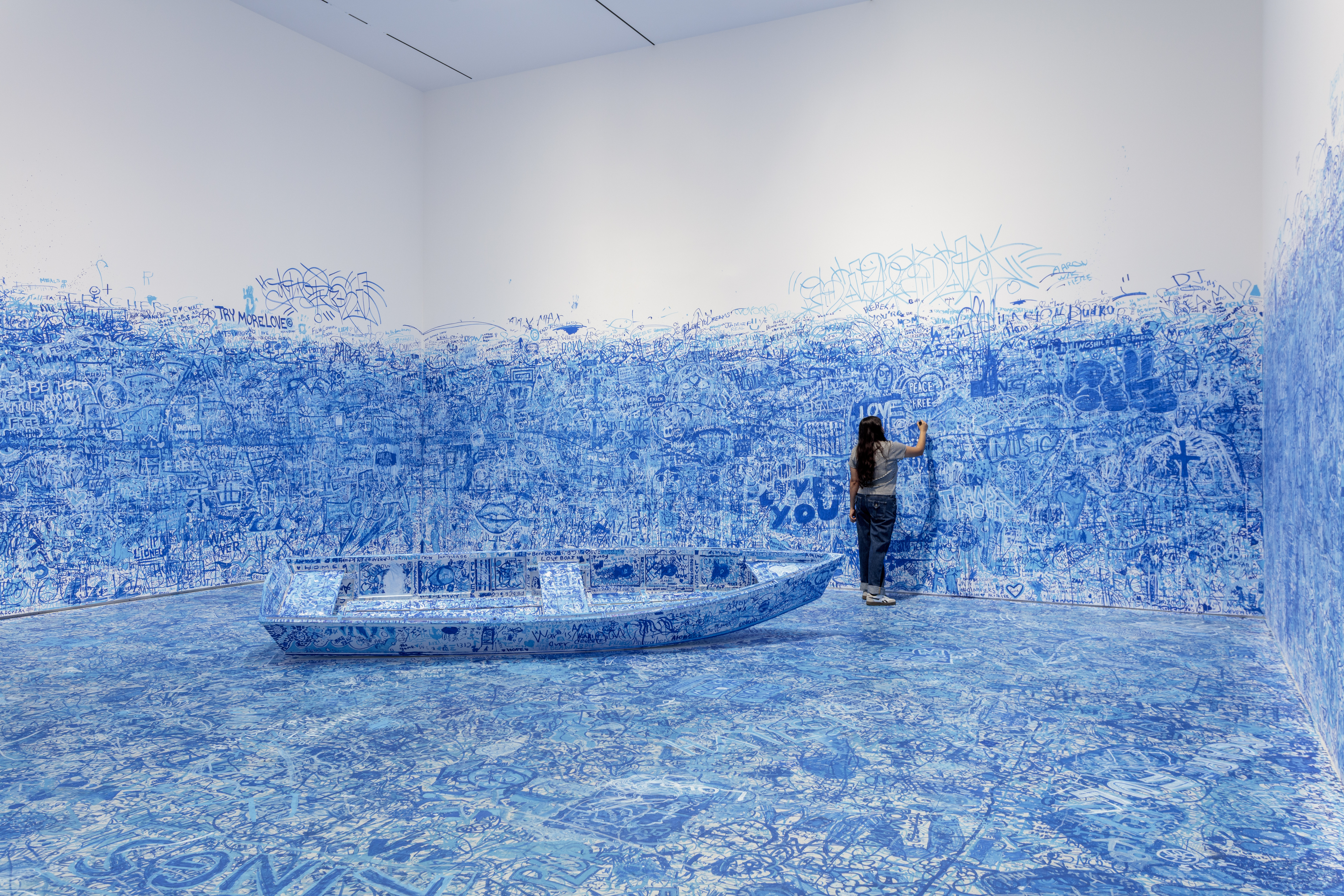 A visitor inside Yoko Ono's Add Colour (Refugee Boat)