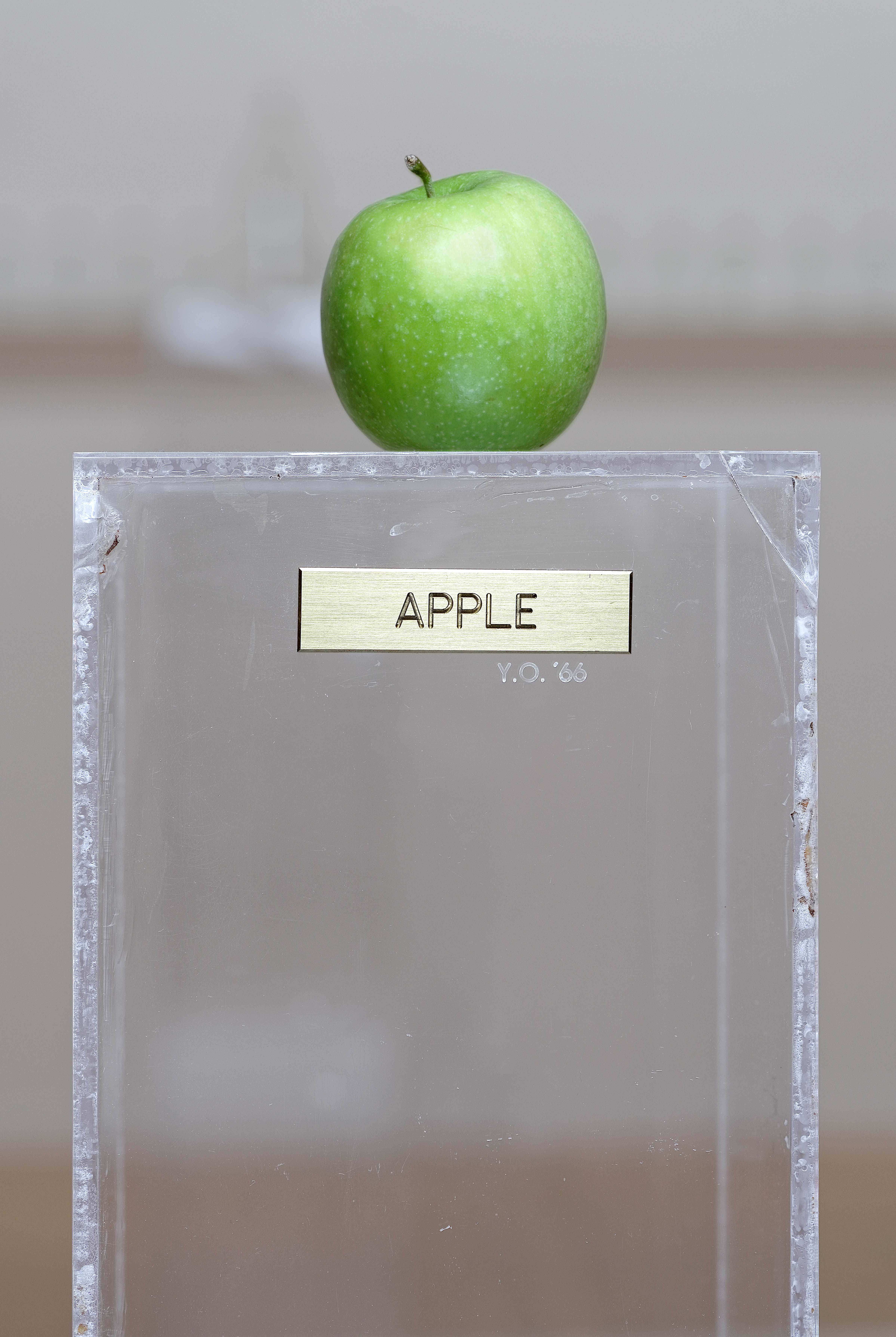 Yoko Ono's Apple, a green apple on a clear pedestal