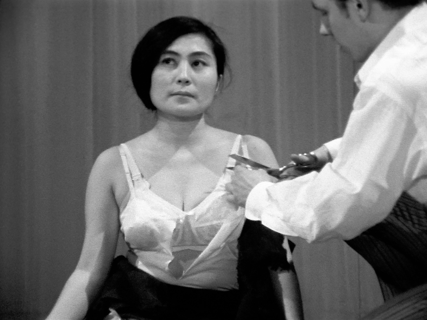 Black-and-white film frame from Yoko Ono's Cut Piece