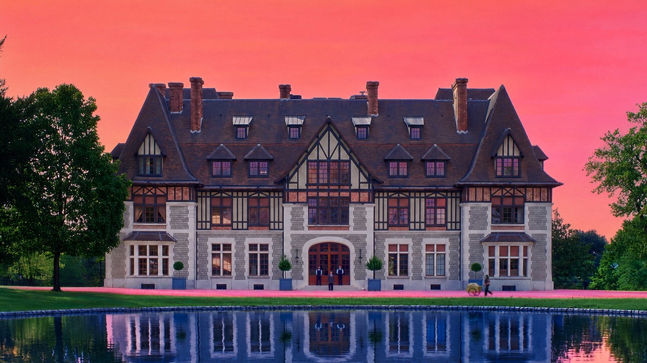 Chateau de Chanteloup reflected in water beneath a vivid pink sky in Prince Gyasi's Maison Martell film