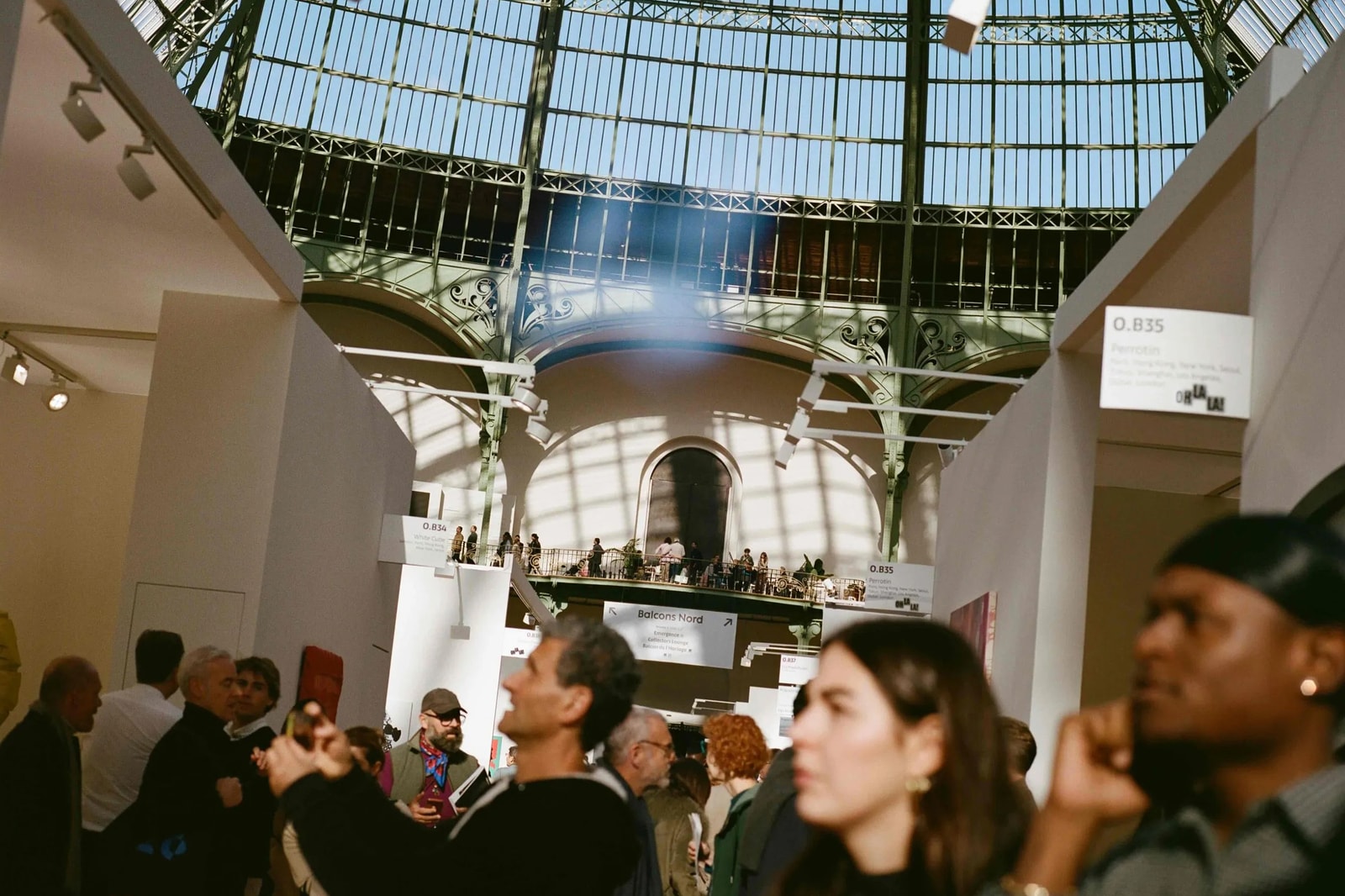 Visitors move through Art Basel Paris beneath the glass roof of the Grand Palais