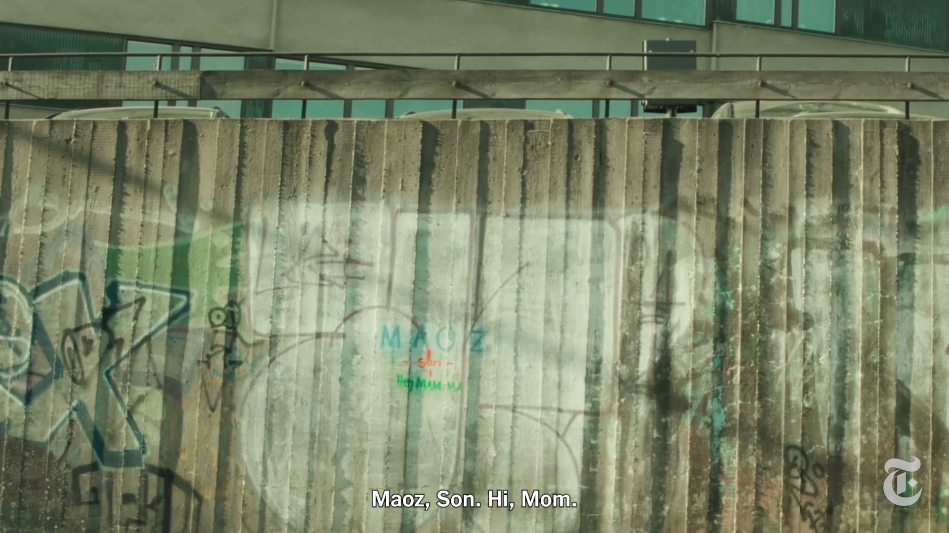 A concrete wall bearing the tags Maoz, Son, and a green Hi Mom response