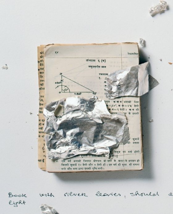 A page from Long Life, Short Stories showing a worn book covered with pieces of silver leaf